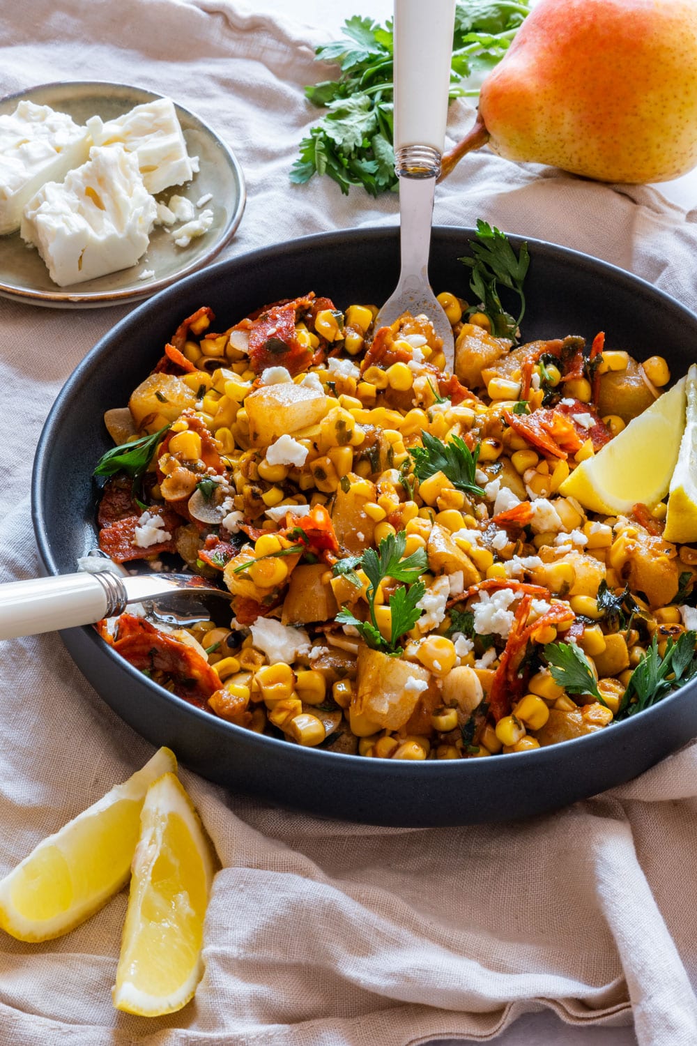 Homemade grilled corn salad with pears on the plate.