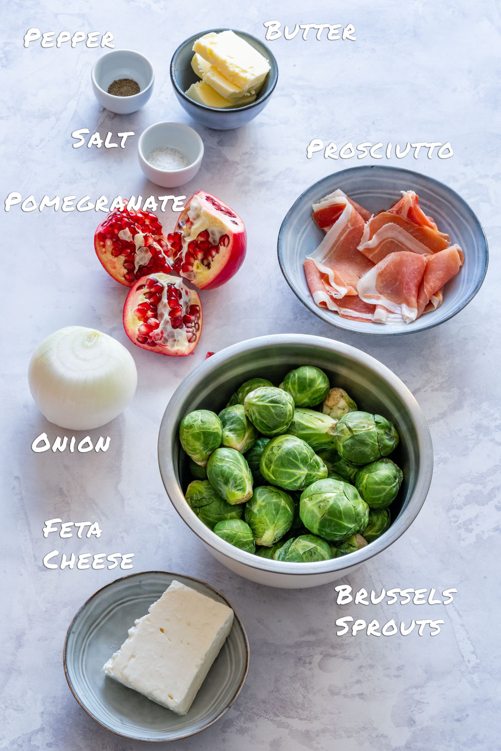 Ingredients of Brussels sprouts salad - Brussels sprouts, prosciutto, feta, onion, pomegranate and butter.