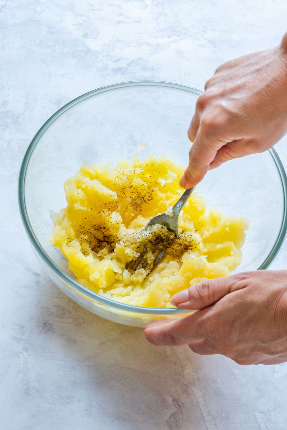 Potato flesh, salt and pepper in the mixing bowl.