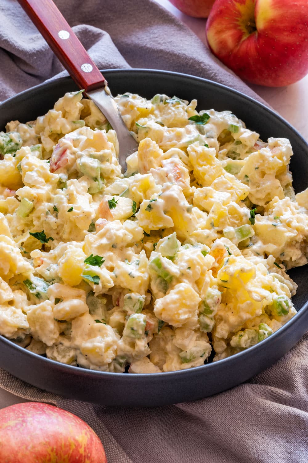 Fresh potato salad on the plate with fork in.