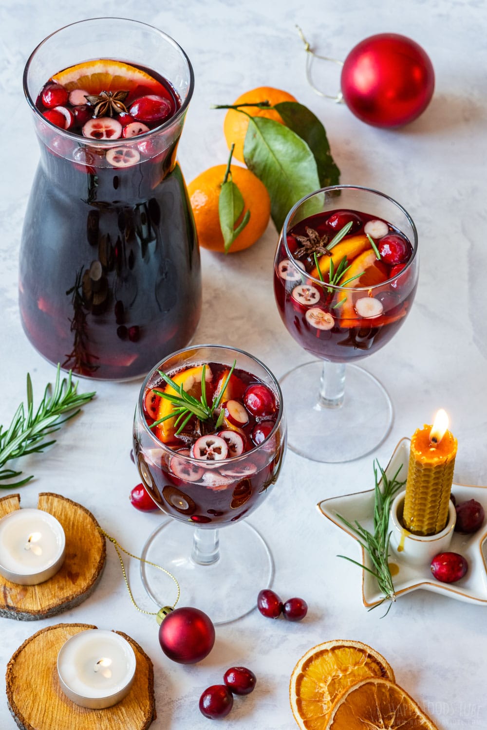 Pitcher and two glasses with Christmas sangria.