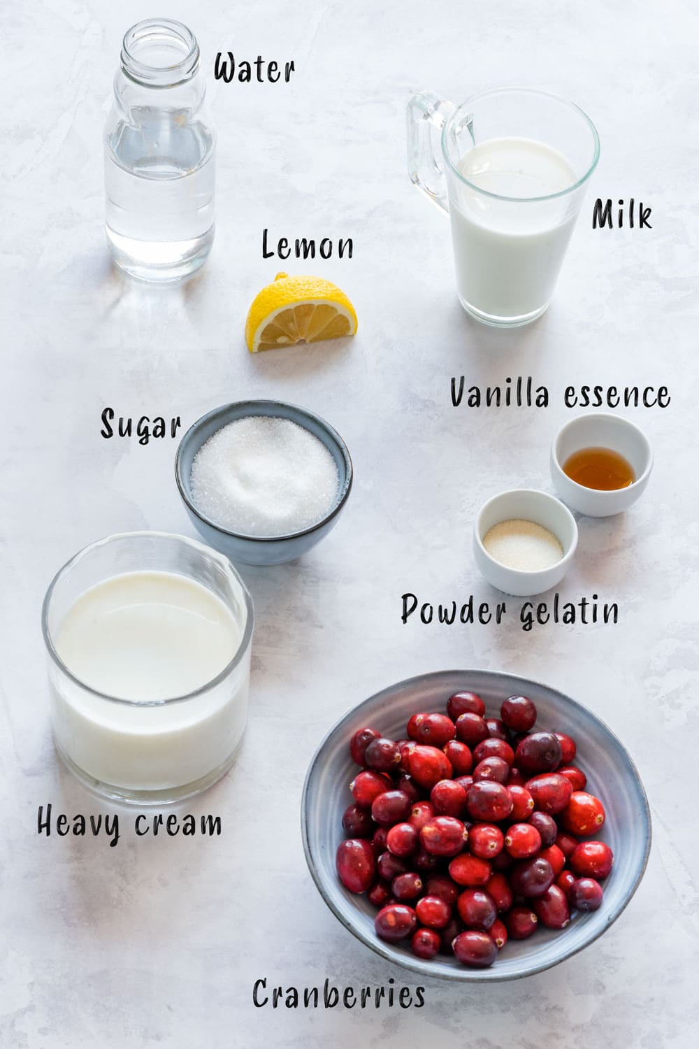 Ingredients of cranberry panna cotta - fresh cranberries, cream, milk, sugar, gelatin, vanilla essence and lemon.
