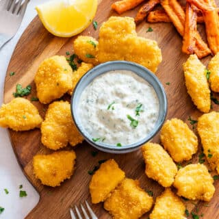 Small bowl of tartar sauce with fried fish.