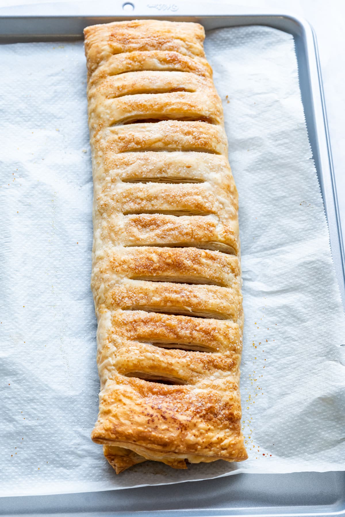 Freshly baked strudel on the baking tray.