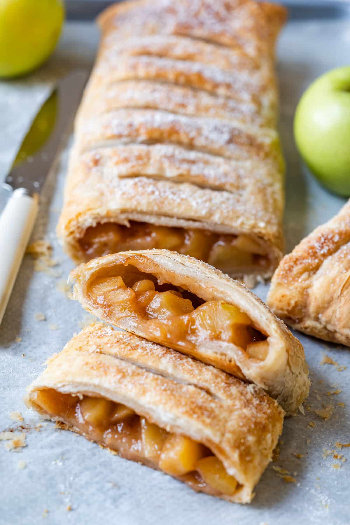 Sliced apple strudel made with puff pastry.