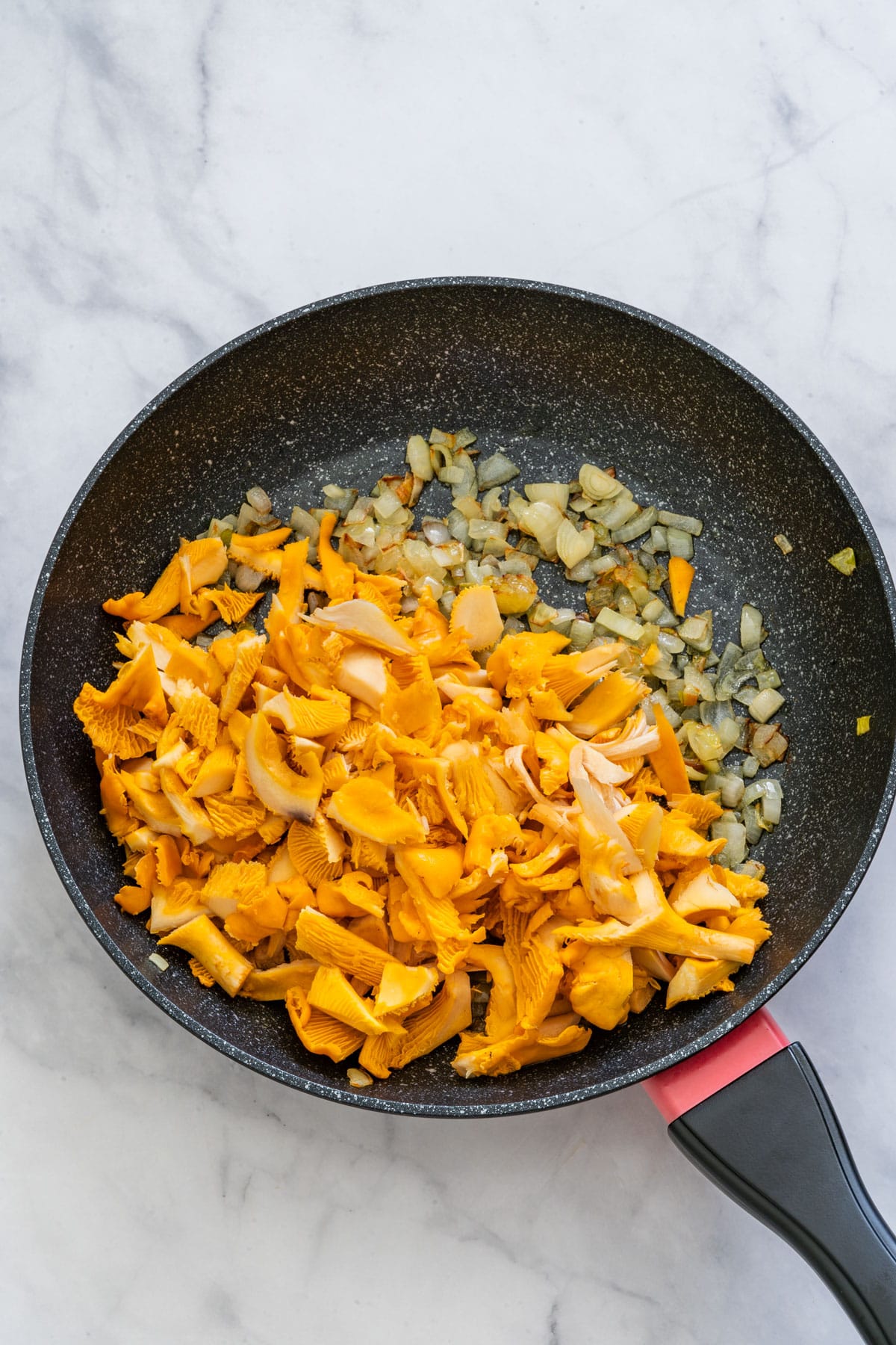 Saute Chanterelle mushrooms and onion on a skillet.