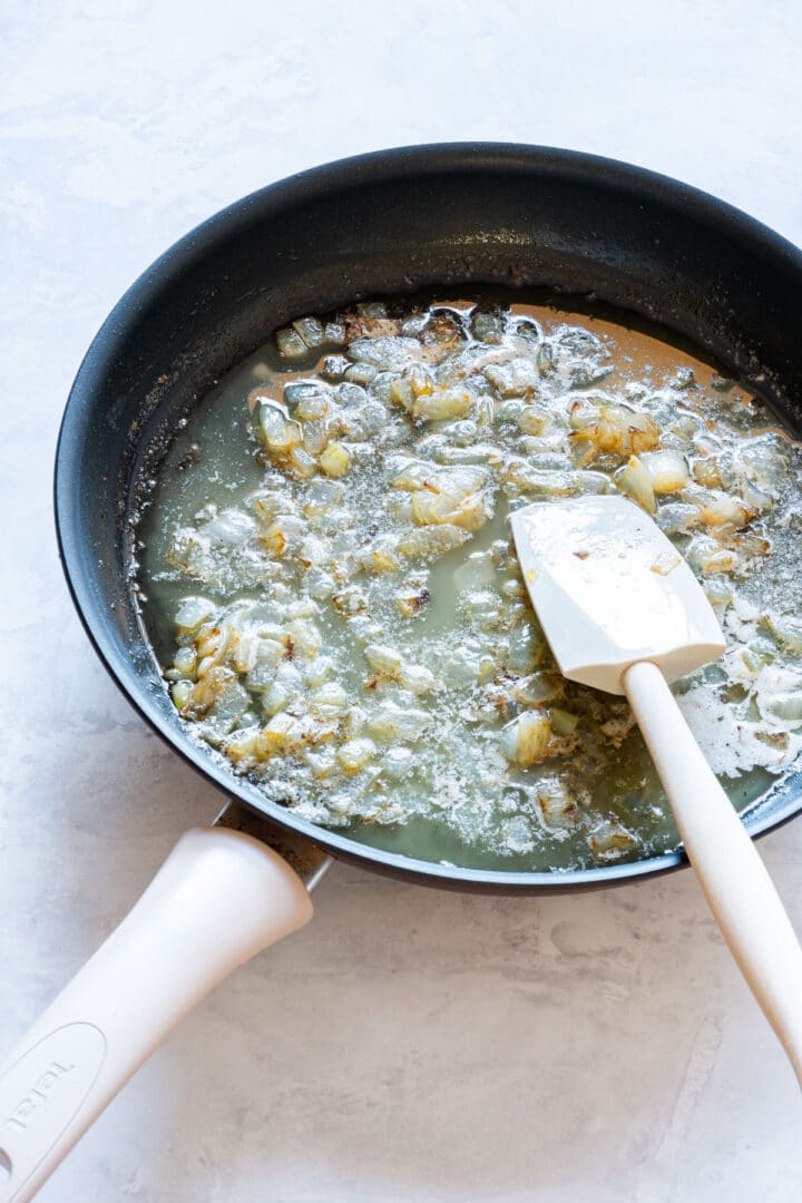 Butter and softened onions sizzling in a skillet for the base.