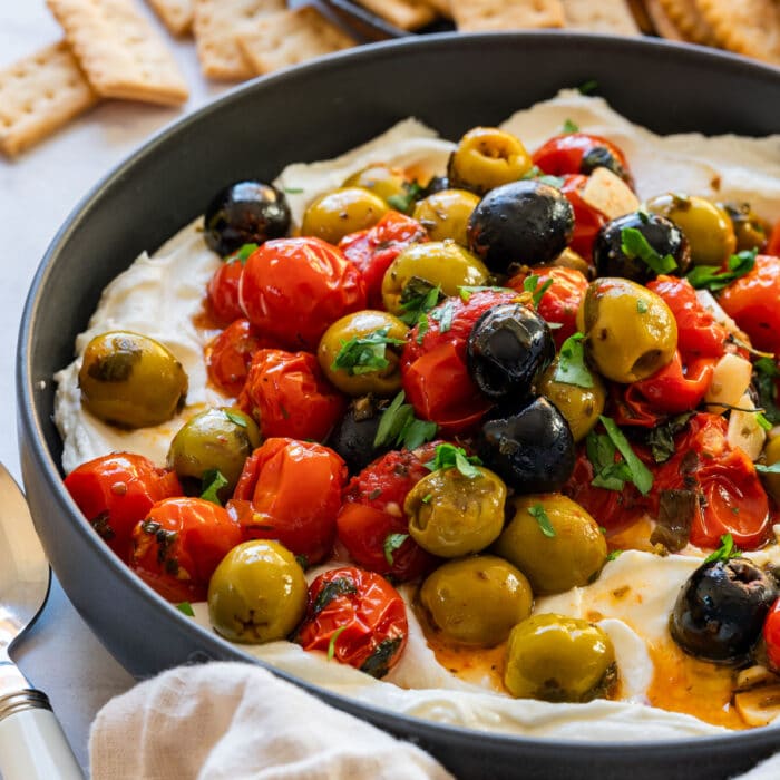 Whipped feta dip topped with roasted cherry tomatoes, green and black olives and herbs.