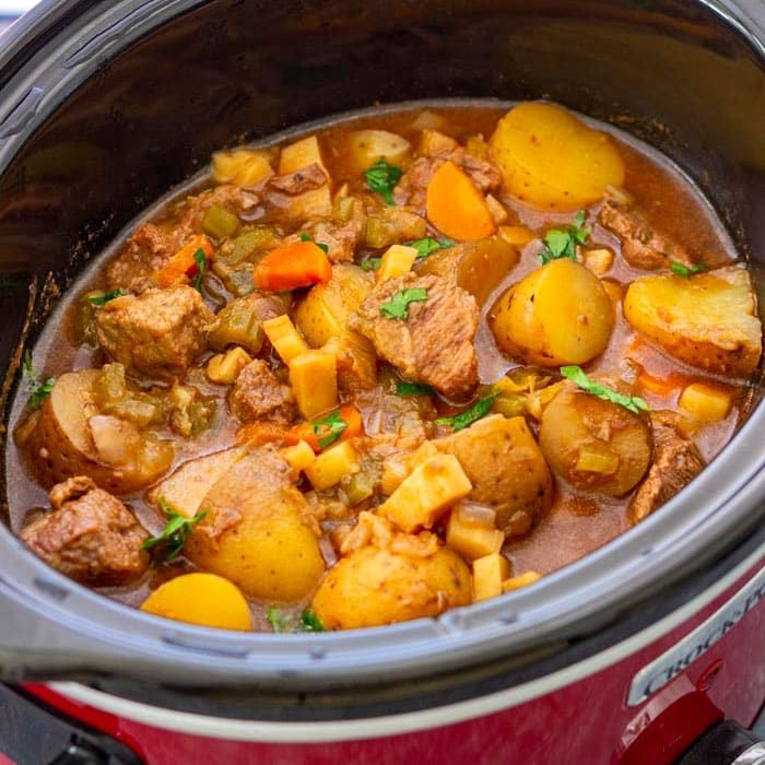 Hearty beef and vegetable stew in a slow cooker.