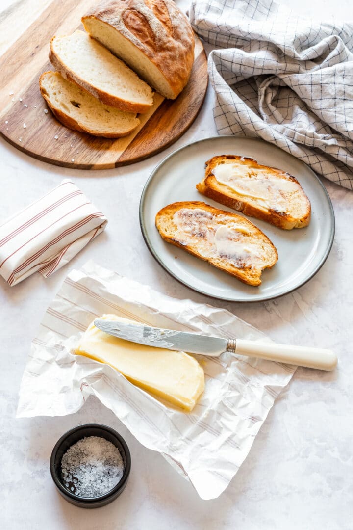 Butter on parchment paper with toasted bread and sea salt.