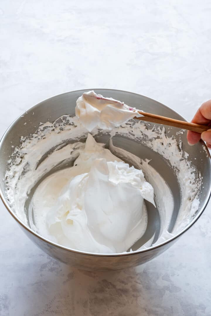 Showing how the meringue should look, glossy with stiff peaks, ready for shaping.