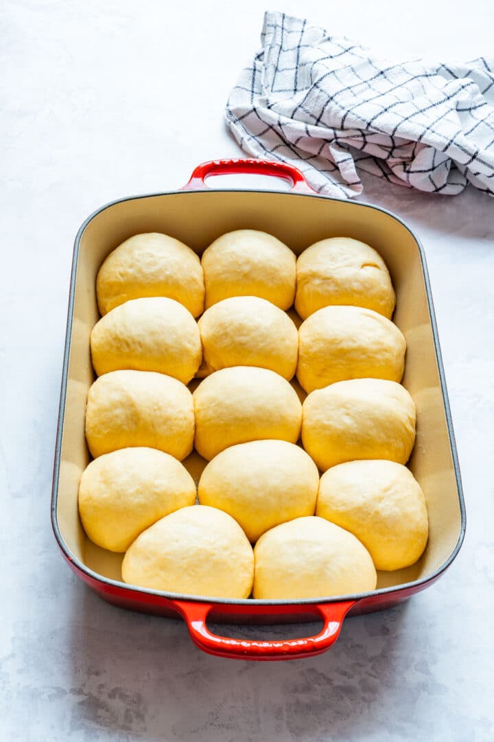Pan of risen dough balls after the second proof, ready to bake.