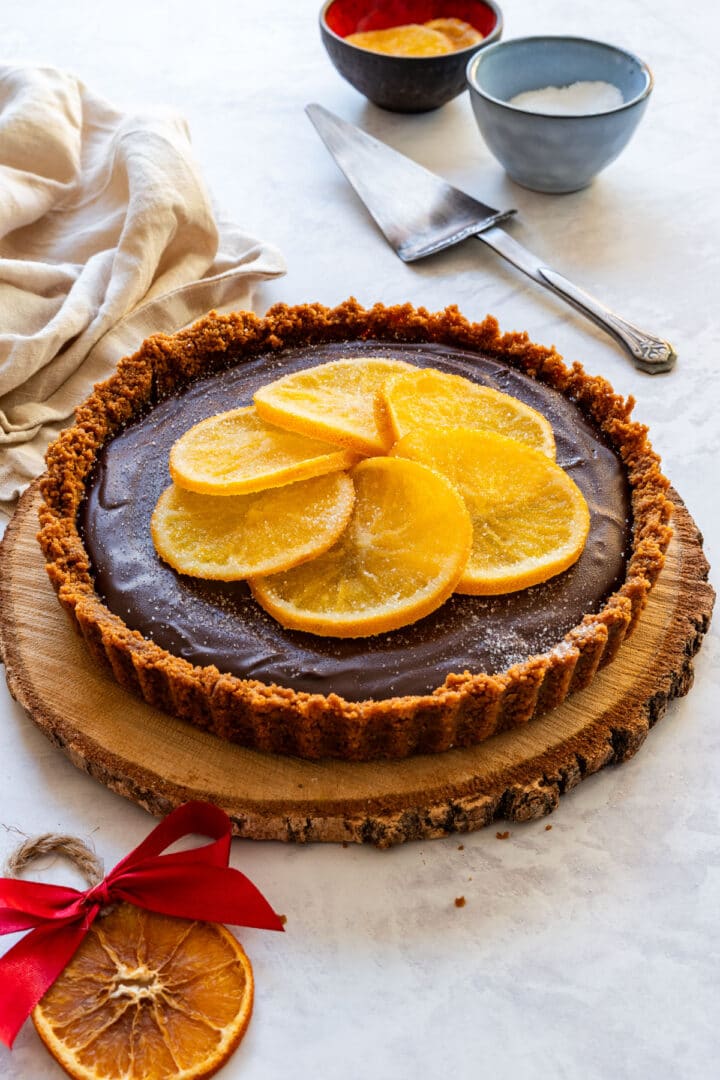 Finished no-bake chocolate tart topped with candied orange slices.