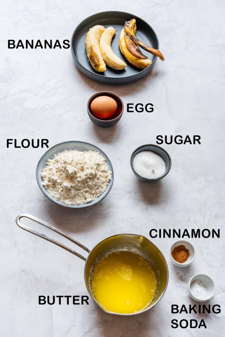Ingredients for simple banana bread: ripe bananas, egg, flour, sugar, melted butter, cinnamon, baking soda.