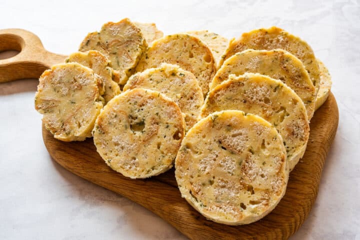 Sliced dumplings arranged on a wooden cutting board.