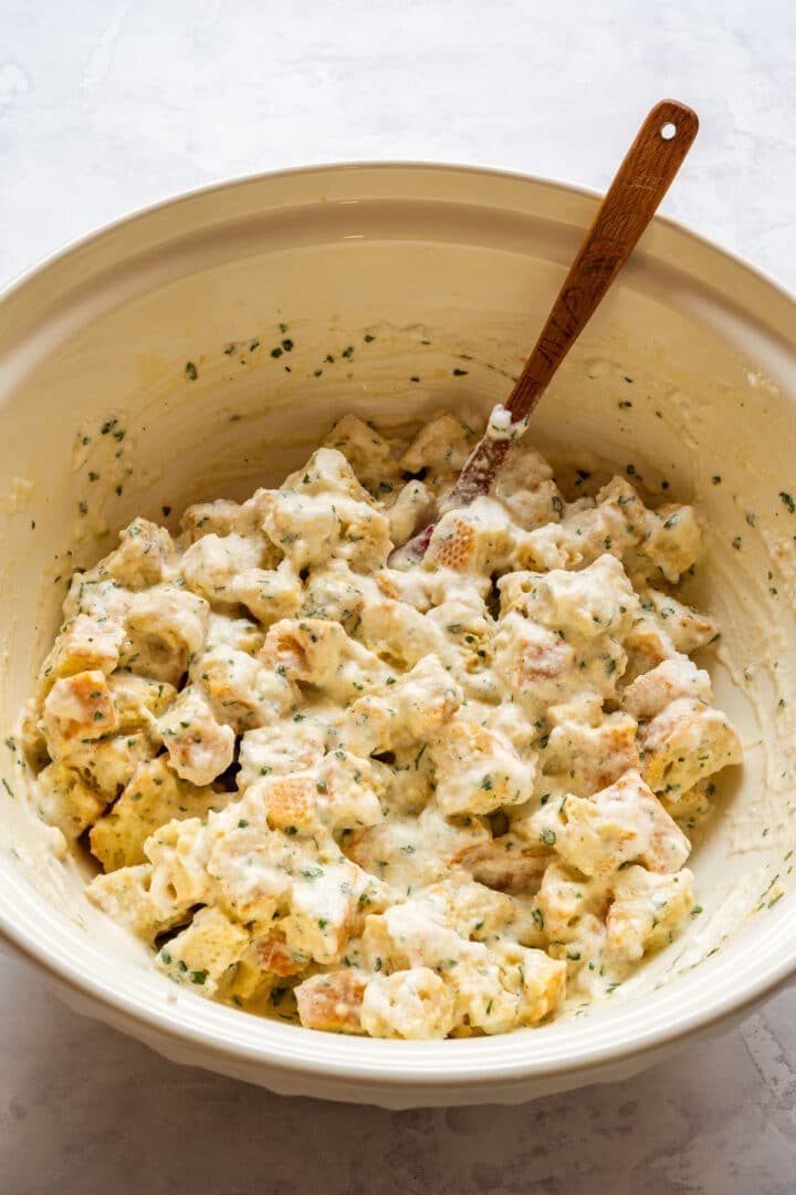 Bread dumpling mixture with baguette cubes coated in egg and milk batter.