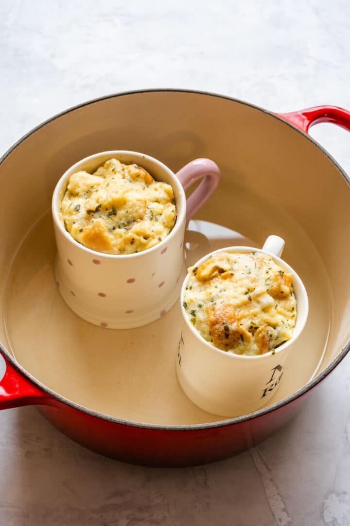 Cooked Carlsbad dumplings risen and set inside ceramic mugs.
