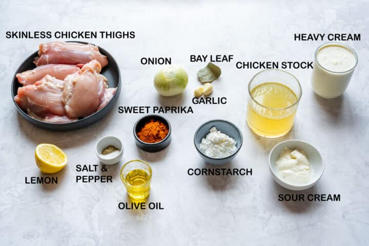 Ingredients for Instant Pot chicken paprikash: chicken thighs, paprika, stock, cream, sour cream, lemon.