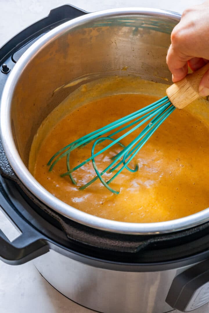 Whisking paprika cream sauce in the Instant Pot to thicken chicken paprikash.