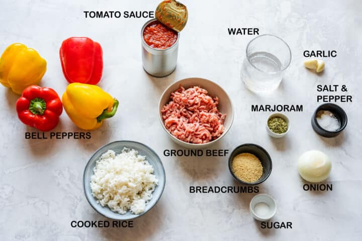 Stuffed bell pepper ingredients: bell peppers, ground beef, cooked rice, onion, garlic, tomato sauce.