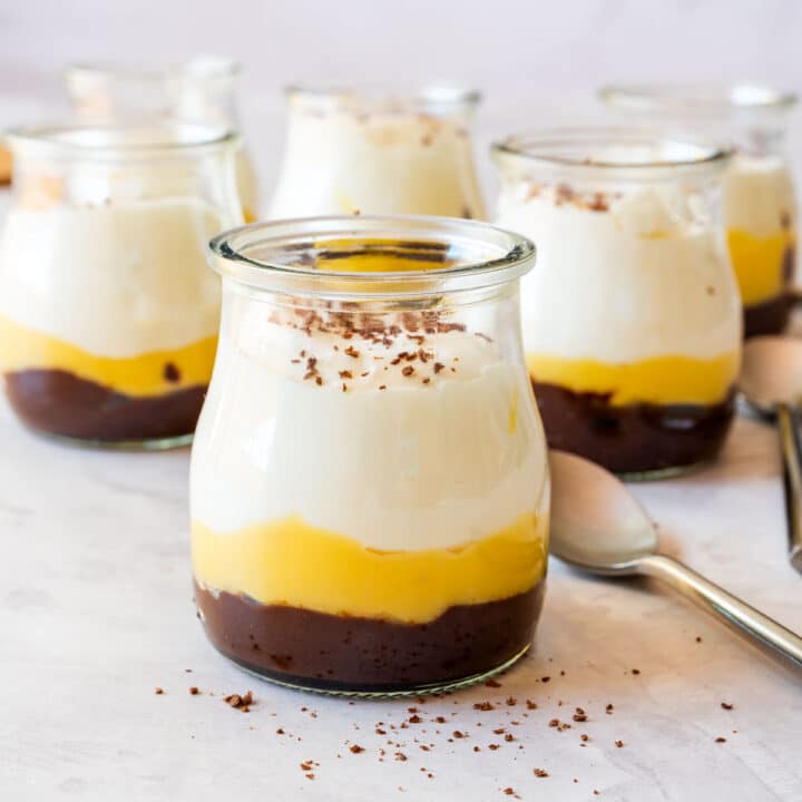 Lemon curd dessert cup with dulce de leche and whipped cream in a small glass.