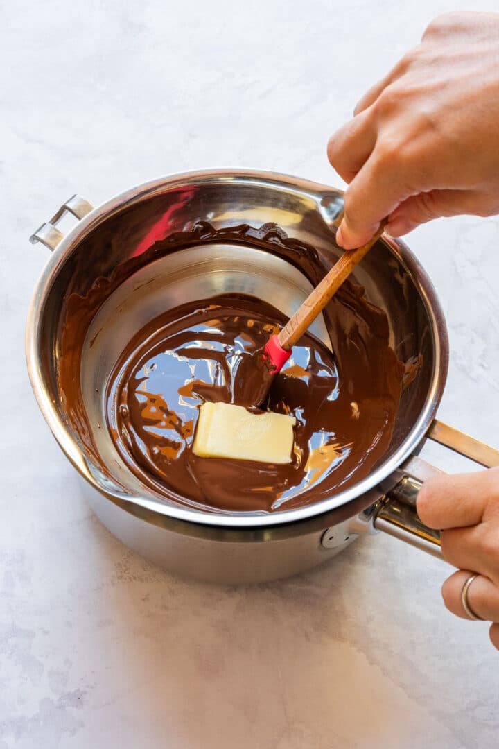 Melting dark chocolate and butter in a double boiler.