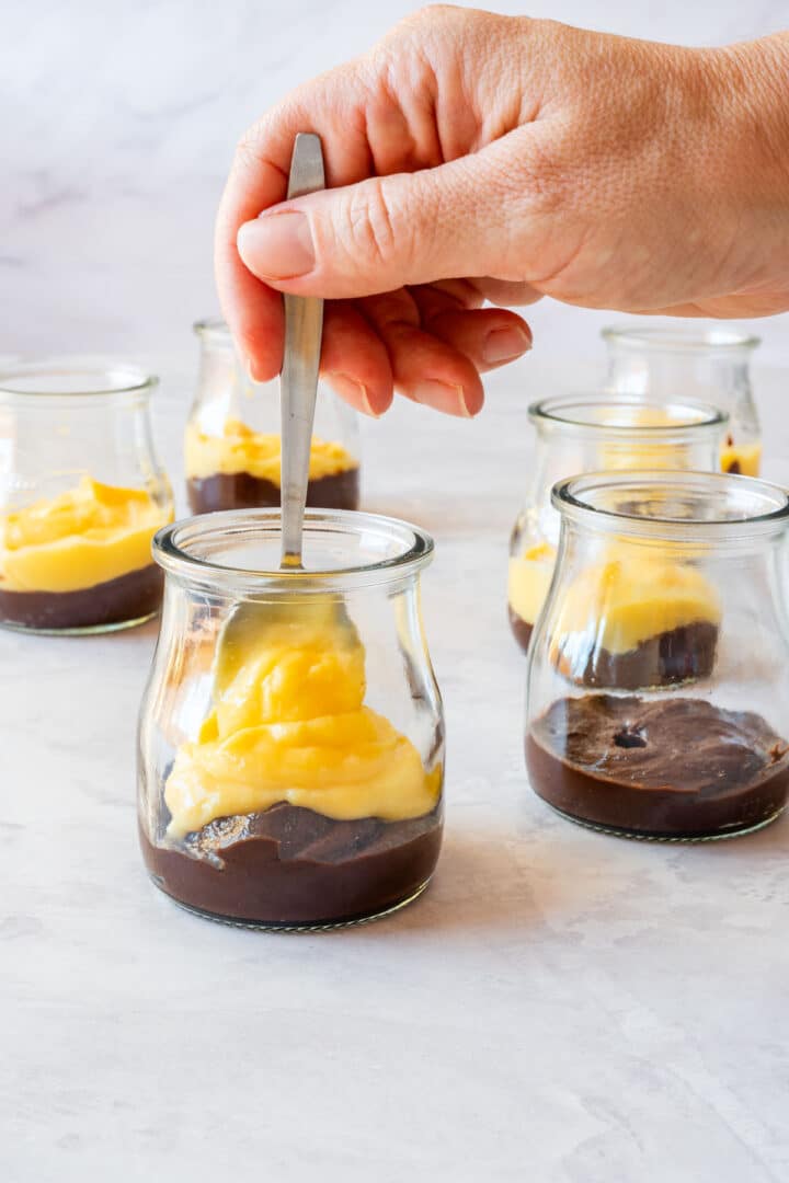 Spoonful of lemon curd added to the chocolate base in a dessert cup.