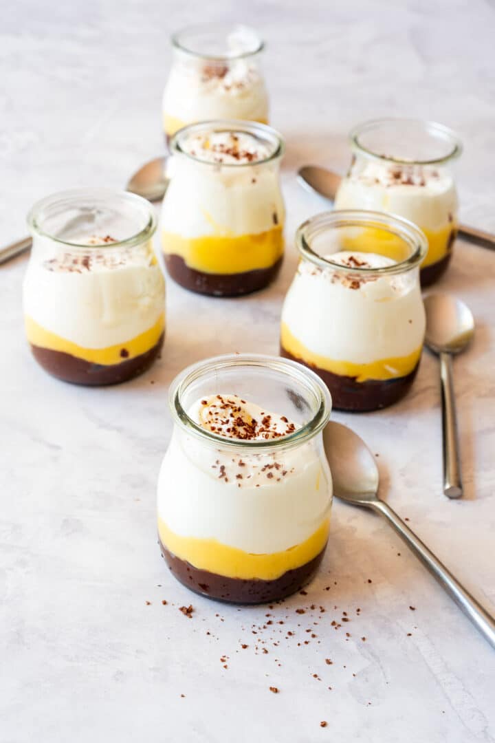 No-bake lemon curd dessert cups with dulce de leche and whipped cream, topped with chocolate shavings.