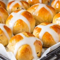 Homemade hot cross buns with white icing crosses.
