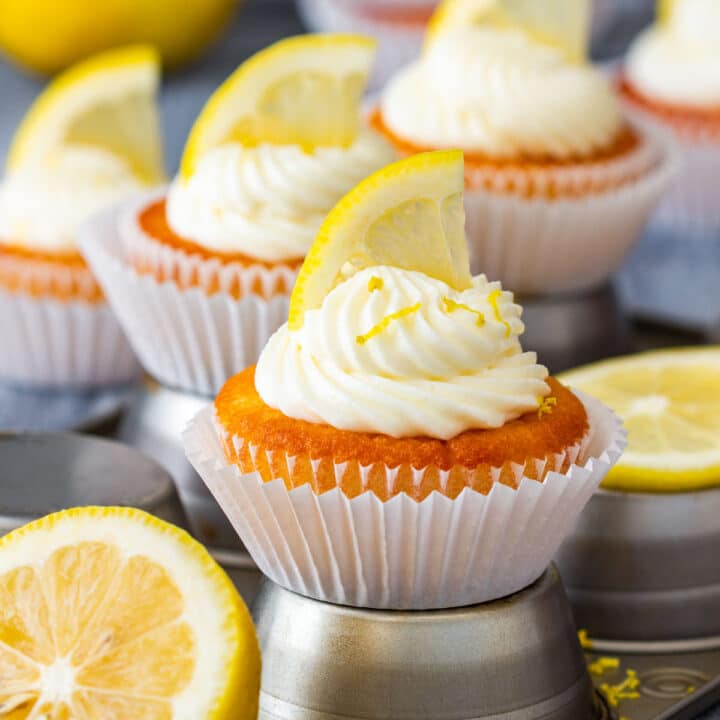 Homemade lemon cupcake with mascarpone frosting, lemon slice and lemon zest.