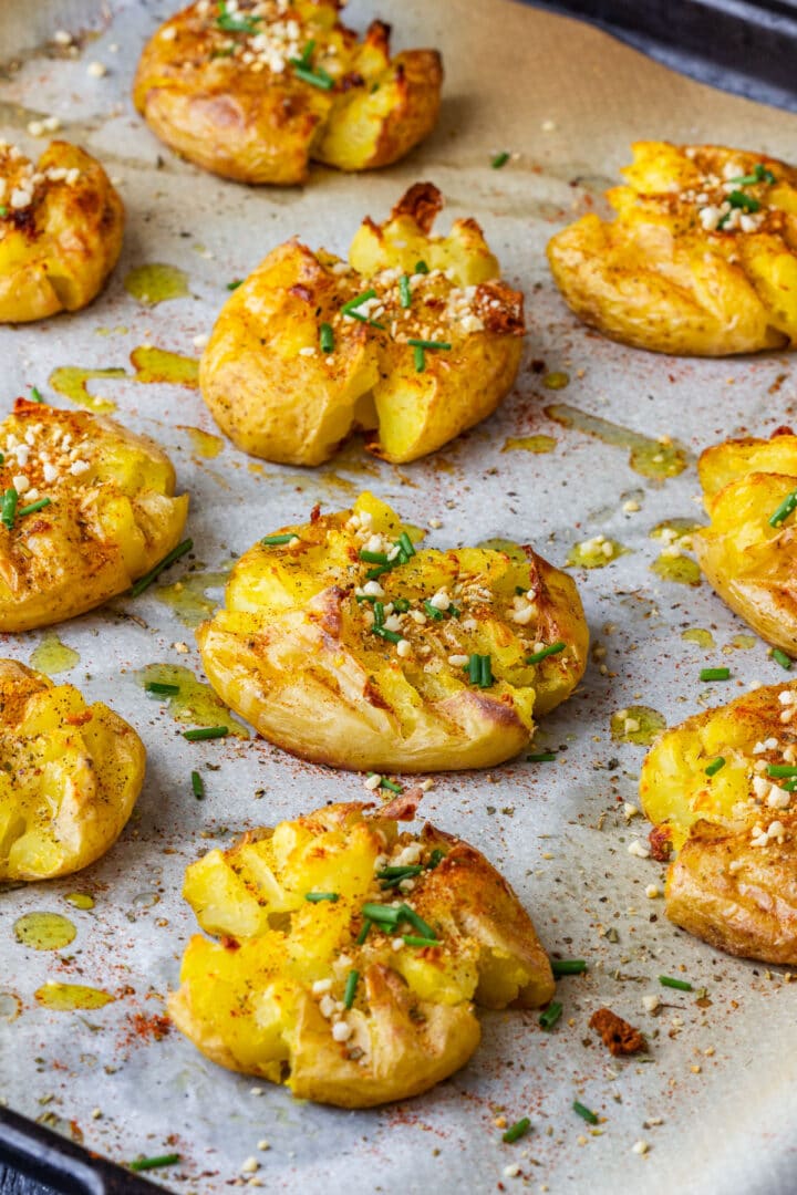 Crispy garlic smashed potatoes baked until golden and topped with chives, paprika and crunchy almonds.