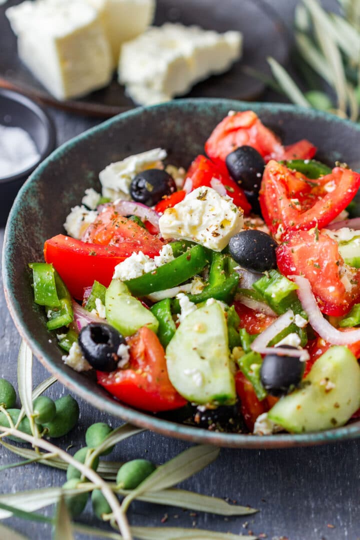 Traditional Greek salad with ripe tomatoes, cucumber, green pepper, red onion, olives and feta in a simple olive oil and oregano dressing. A fresh side dish for summer, ready in about 10 minutes.