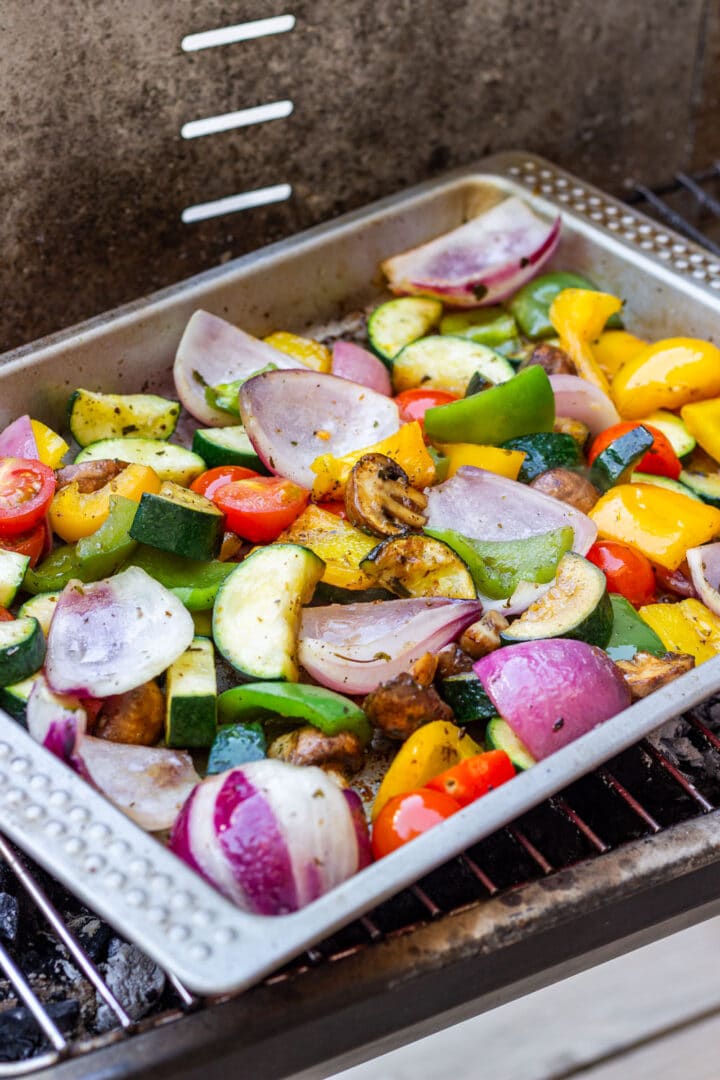Easy Mediterranean grilled vegetables made in one tray on the grill. No skewers, nothing falls through the grates, and you can swap in whatever summer veg you have. A simple, colorful side for any cookout.