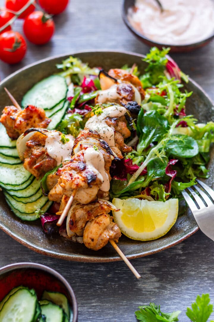 Chicken kabobs served on mixed salad with cucumber, lemon and ketchup-mayo sauce.