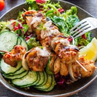 Fajita-marinated chicken kabobs with onion and green pepper served over fresh salad.