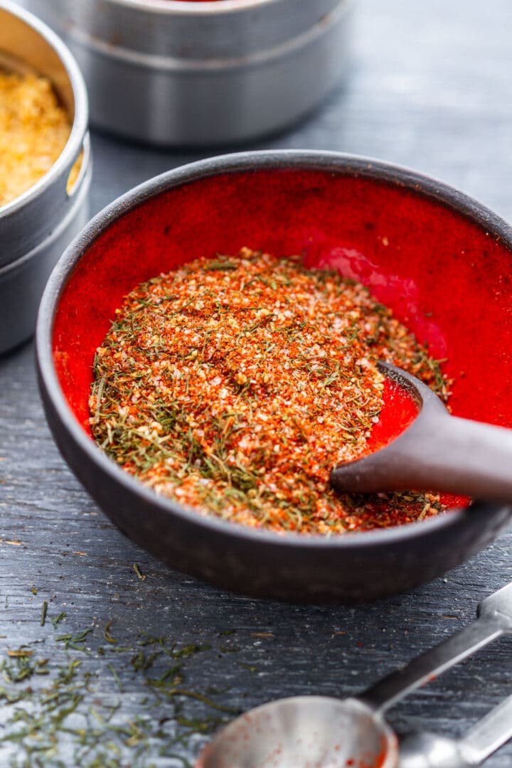 Close-up of mixed fish seasoning with paprika, dried dill, garlic powder and salt.