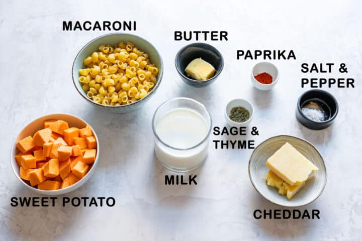 Ingredients for sweet potato mac and cheese: diced sweet potato, macaroni, butter, milk, cheddar, paprika, sage, thyme, salt and pepper.