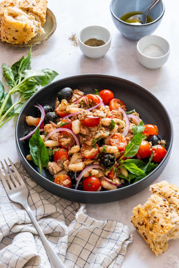 Tuna white bean salad made with canned tuna, cannellini beans, cherry tomatoes, black olives and fresh herbs, dressed with olive oil and balsamic vinegar. A no-cook Mediterranean salad ready in 5 minutes, great for lunch or as a side.